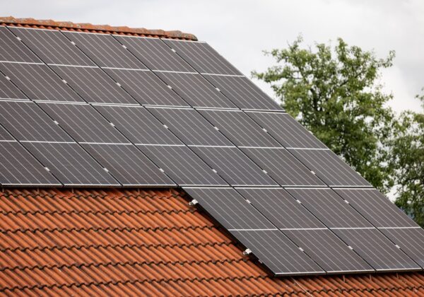 A closeup of solar panels installed on a suburban home's rooftop