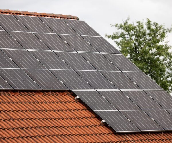 Closeup of solar panels installed on a suburban home's rooftop A closeup of solar panels installed on a suburban home's rooftop